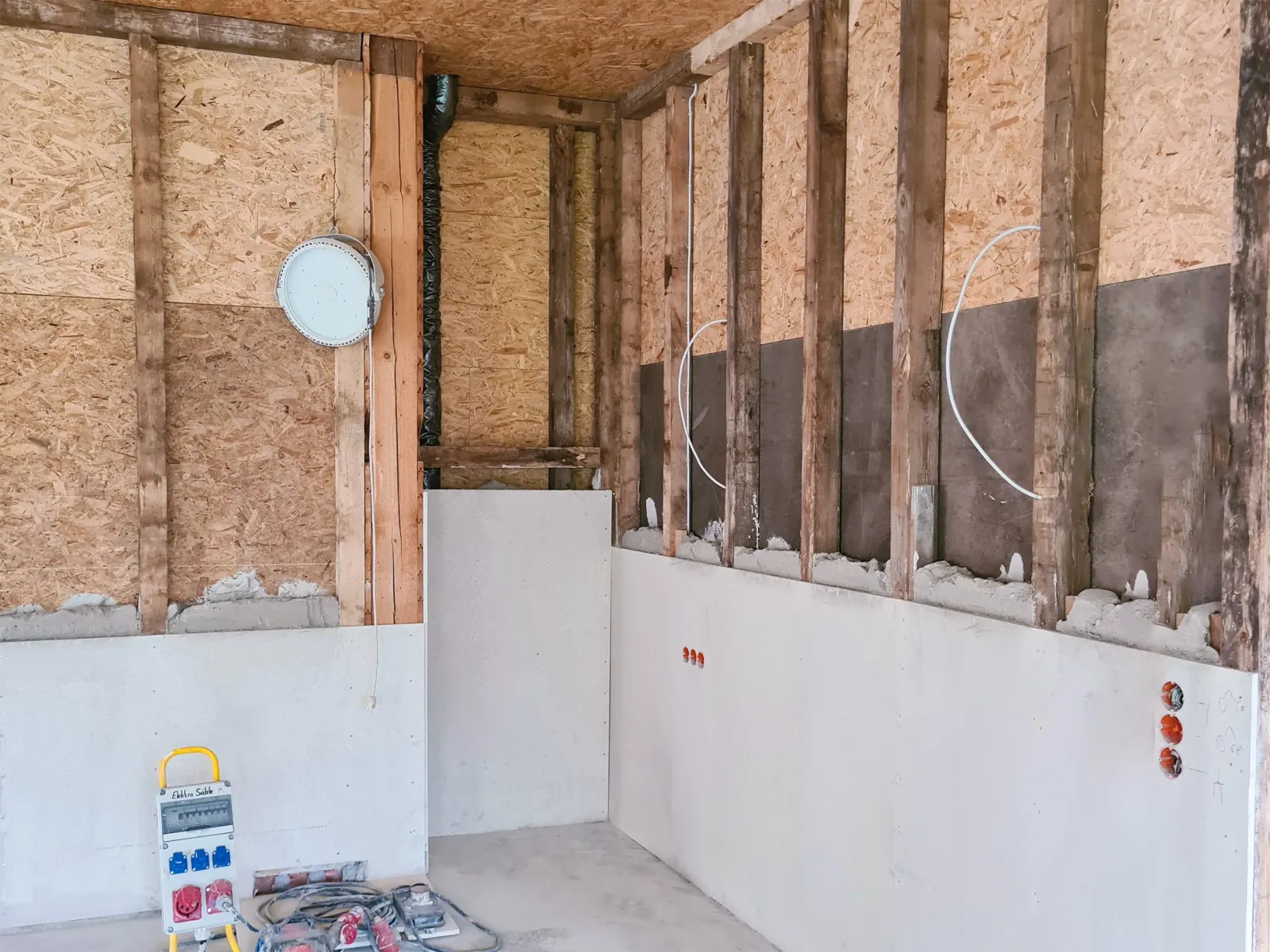 Innenraum einer Wand während der Sanierung mit sichtbarer Holz- und Dämmstruktur